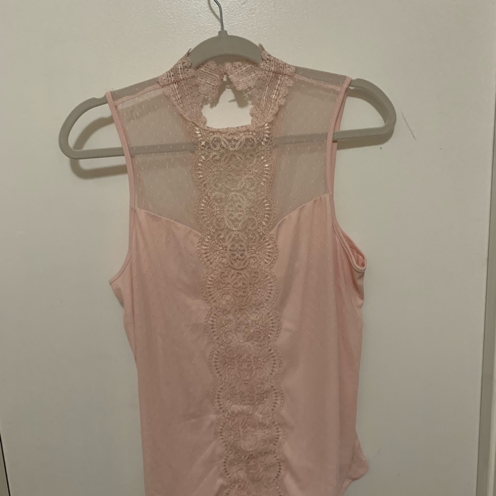 Add a dose of elegance to your wardrobe with this beautiful lace high-neck top.